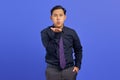 Portrait of charming young Asian man hold hand palms send air kiss on purple background Royalty Free Stock Photo