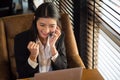 Portrait charming young Asian woman in formal suit celebrating success with arms up while talking with cell phone in front of Royalty Free Stock Photo