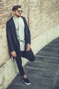 Portrait of charming young man with sunglasses outdoors