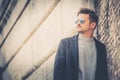 Portrait of charming young man with sunglasses outdoors