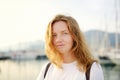 Portrait of charming young tourist woman on the Mediterranean coast. Attractive red-haired girl hiking by the sea shore. Tourism, Royalty Free Stock Photo