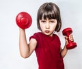 Portrait of cheeky pouting child raising dumbbells for feminism Royalty Free Stock Photo