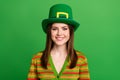 Portrait of cheerful adorable girl beaming smile wear st patrick theme hat isolated on green color background