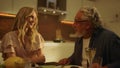 Portrait of cheerful adult daughter and senior father sitting at dining table Royalty Free Stock Photo