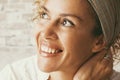 Portrait of cheerful adult woman smiling and enjoying life at home sitting on the sofa. Excited expression female people looking