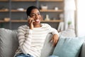 Portrait Of Cheerful African American Female Talking On Mobile Phone At Home