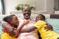 Portrait of cheerful african american senior man with grandson and granddaughter at home Royalty Free Stock Photo