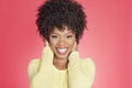 Portrait of a cheerful African American woman with hands over ears