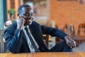 Portrait of cheerful african executive business man using smartphone