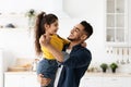 Portrait Of Cheerful Arab Dad Dancing With His Little Daughter At Home