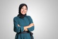 Portrait of cheerful Asian muslim woman with hijab, keeping arms crossed and smiling looking at camera. Isolated image on white Royalty Free Stock Photo