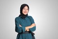 Portrait of cheerful Asian muslim woman with hijab, keeping arms crossed and smiling looking at camera. Isolated image on white Royalty Free Stock Photo