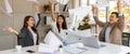 Portrait of cheerful Asian office workers smiling happily and cerebrate by throwing paperwork to the air in a meeting room. Royalty Free Stock Photo