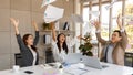 portrait of cheerful Asian office workers smiling happily and cerebrate by throwing paperwork to the air in a meeting room. Royalty Free Stock Photo