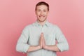 Portrait of cheerful attractive hopeful guy hands together toothy beaming smile please on pink background Royalty Free Stock Photo