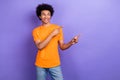 Portrait of cheerful attractive man look direct fingers empty space novelty isolated on purple color background Royalty Free Stock Photo