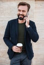 Portrait of a cheerful bearded man holding coffee cup Royalty Free Stock Photo