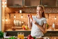 Vegetables keep you healthy. Happy young woman cooking vegetables in modern kitchen. Cozy interior Royalty Free Stock Photo