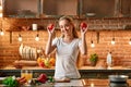 I guess I fell into cooking. Happy young woman cooking vegetables in modern kitchen. Cozy interior Royalty Free Stock Photo