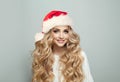 Portrait of cheerful blonde woman in Santa hat smiling on white banner background, Christmas model Royalty Free Stock Photo