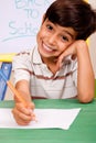 Portrait of cheerful boy writing notes Royalty Free Stock Photo