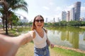 Portrait of cheerful Brazilian girl takes selfie in Vaca Brava Park in Goiania, Goias, Brazil Royalty Free Stock Photo