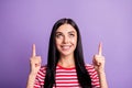 Portrait of cheerful brunette lady point look empty space wear red striped t-shirt subscribe follow isolated on violet