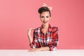 Portrait of a cheerful brunette pin-up girl in plaid shirt Royalty Free Stock Photo