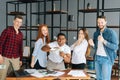 Portrait of cheerful business team of multi-ethnic employees celebrating victory and big profit. Royalty Free Stock Photo