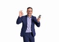 Portrait of cheerful businessman with mobile phone screaming and showing OK sign on white background Royalty Free Stock Photo