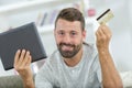 Portrait cheerful businessman paying for order with credit card