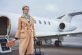 Outgoing lady situating opposite aircraft