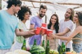 Portrait of cheerful carefree people hold plastic cup have fun hanging out beach party outdoors Royalty Free Stock Photo