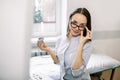 Portrait of cheerful Caucasian woman ultrasound specialist, holding ultrasound sensor of modern ultrasonic scanner