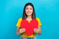 Portrait of cheerful chinese girl wear t-shirt hold red paper postcard gift fans heart symbol anniversary isolated on Royalty Free Stock Photo