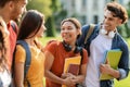 Portrait of cheerful college friends walking to class together outdoors Royalty Free Stock Photo