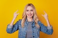 Portrait of cheerful crazy rock fan girl make horns sign gesture beaming smile on yellow background