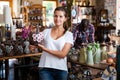 Portrait cheerful customer picking glazed crockery in ceramics workshop