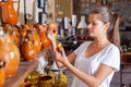 Portrait cheerful customer picking glazed crockery in ceramics workshop Royalty Free Stock Photo