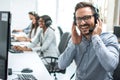 Portrait of cheerful customer support telephone operator in call centre Royalty Free Stock Photo