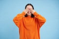 Portrait of cheerful cute asian girl waits for surprise, shuts her eyes with hands, birthday girl awaiting for gift Royalty Free Stock Photo