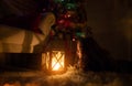 Portrait of a cheerful cute girl near a Christmas tree with a lantern. New Year holidays Royalty Free Stock Photo