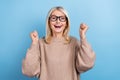 Portrait of cheerful delighted lady raise fists shout yes accomplishment isolated on blue color background Royalty Free Stock Photo