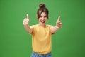 Portrait of cheerful enthusiastic and excited emotive beautiful european woman in yellow t-shirt pulling hands with