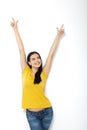 Portrait of cheerful European woman with hands raised pointing up