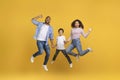 Cheerful Excited African American Family Of Three Holding Hands And Jumping Royalty Free Stock Photo