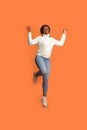 Portrait Of Cheerful Excited African American Woman Jumping In Air With Raised Hands Royalty Free Stock Photo
