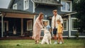 Portrait of a Cheerful Family Couple with Kids, Playing and Petting a Beautiful White Golden Royalty Free Stock Photo