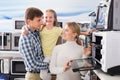 Portrait of cheerful family selecting microwave