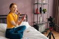 Portrait of cheerful female beauty blogger applying blusher on face using brush looking at camera, sharing knowledge Royalty Free Stock Photo